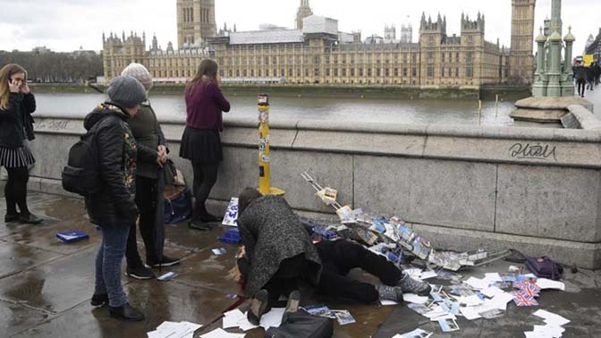 An injured woman is assisted after an incident on Westminster Bridge in London