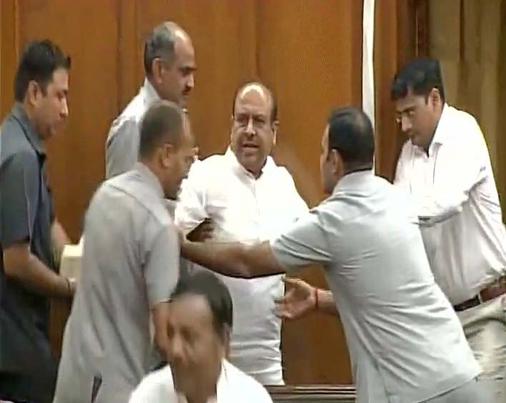 Bharatiya Janata Party MLA Vijendra Gupta being marshaled out from Delhi Assembly 