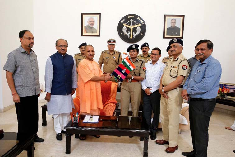 Uttar Pradesh Chief Minister presents the Indian Flag to IPS Aparna Kumar