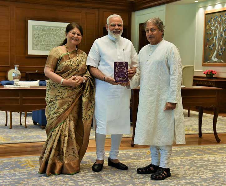 Amjad Ali Khan presents his book to PM Modi