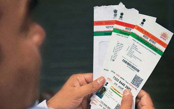 A view of man holding Aadhaar card (File Photo)