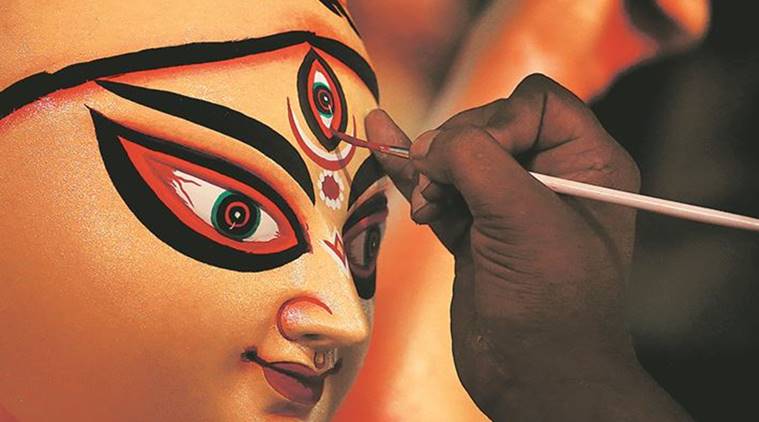 An artisan works on an idol of Durga at a workshop