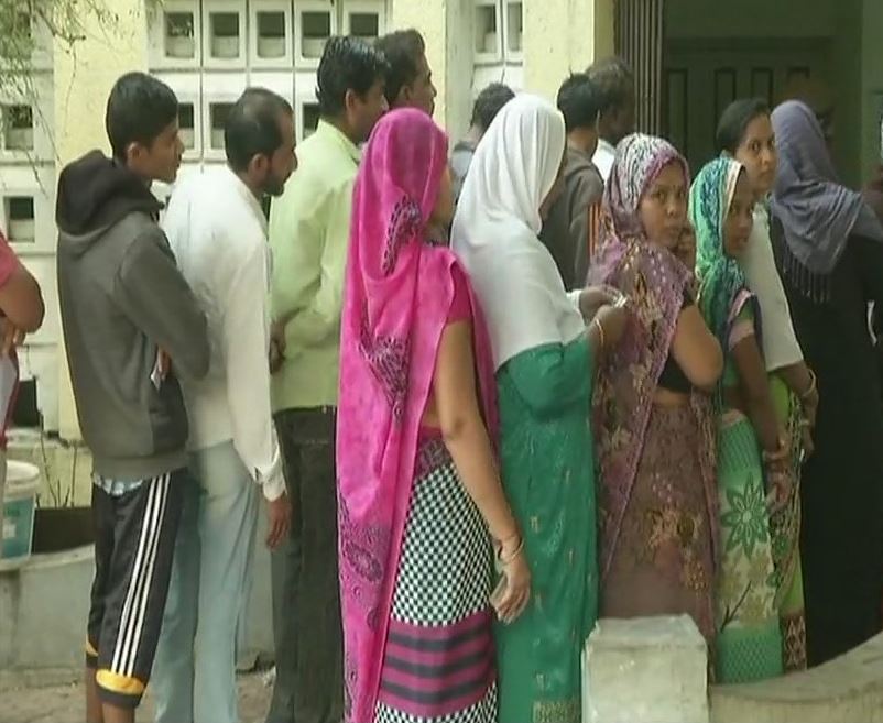 People wait in queue to cast their vote in Bharuch's Ankleshwar