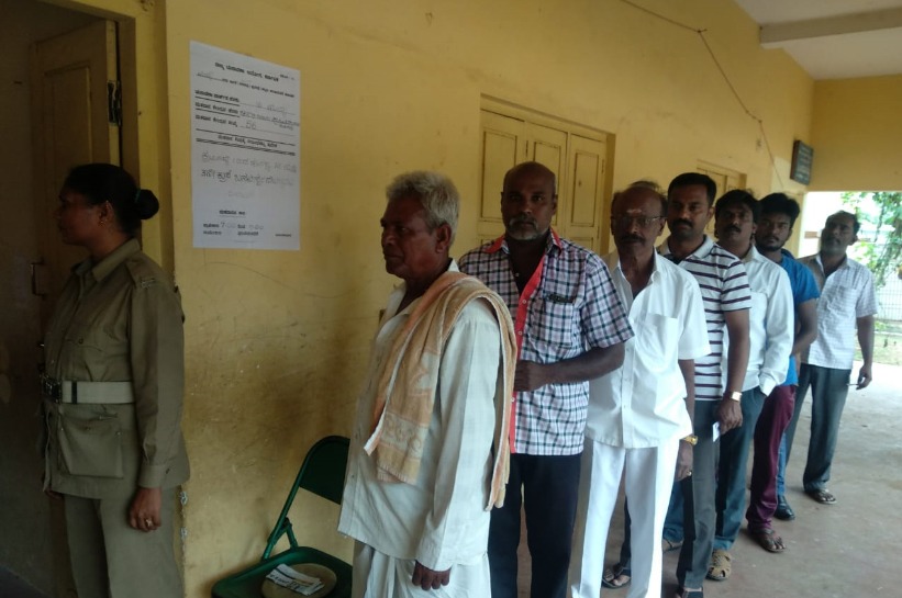 People Standing in queue to cast their vote