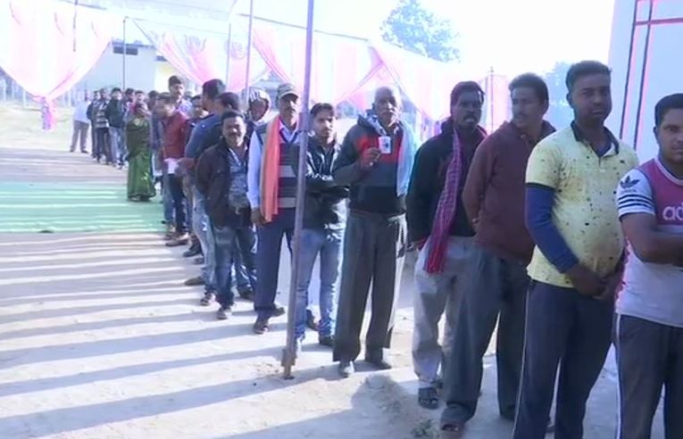 People standing in queue for casting their votes