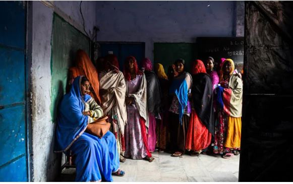 People Standing in queue to cast their vote