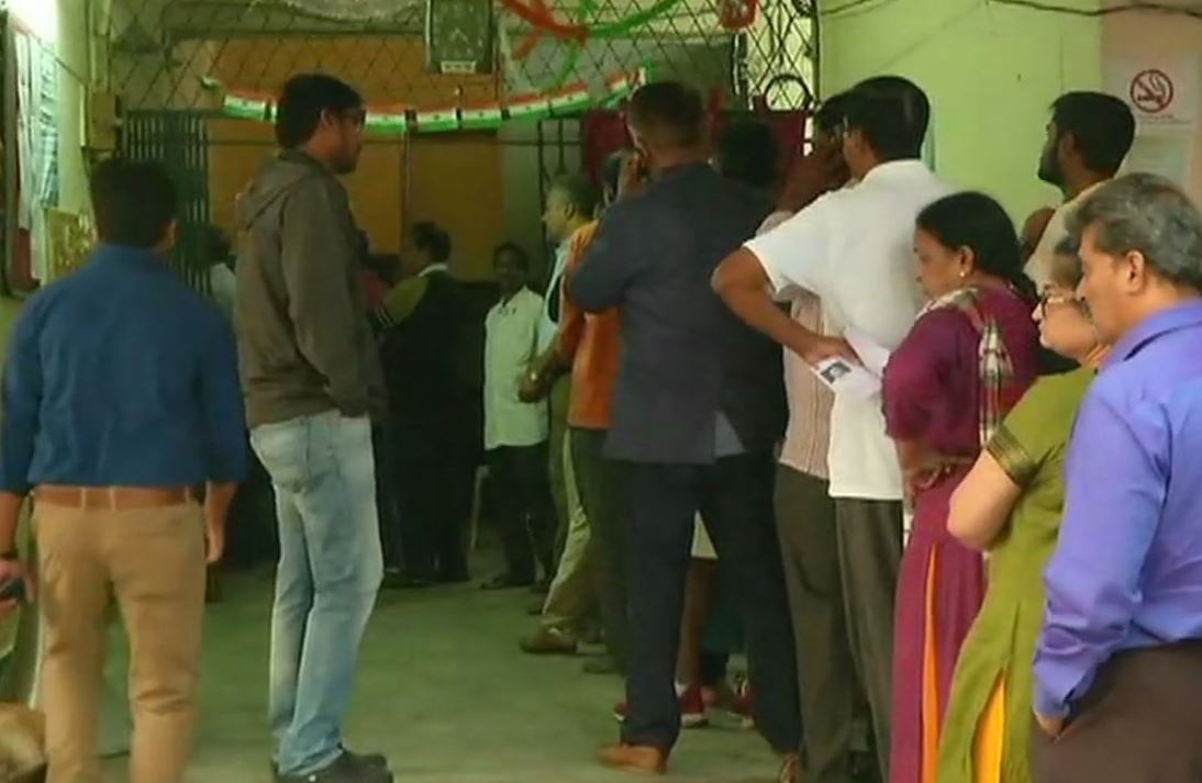 People Standing in queue to cast their vote