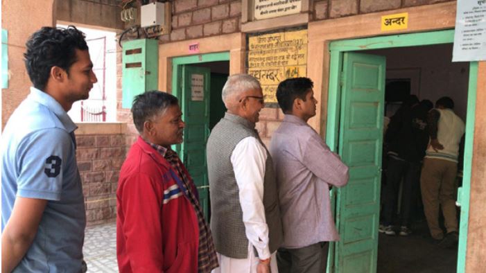 People Standing in queue to cast their vote