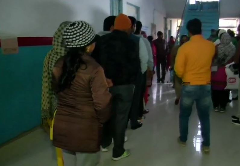 People Standing in queue to cast their vote