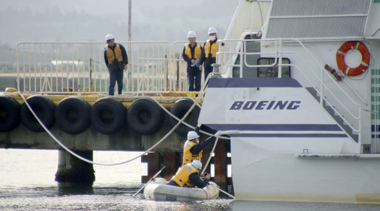 Coast guard crew investigate the damage of a ferry which collided at a port in Sado city, Niigata prefecture