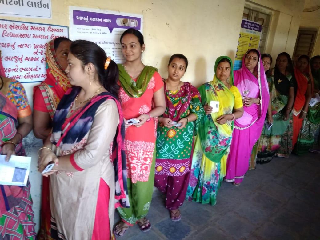 People Standing in queue to cast their vote