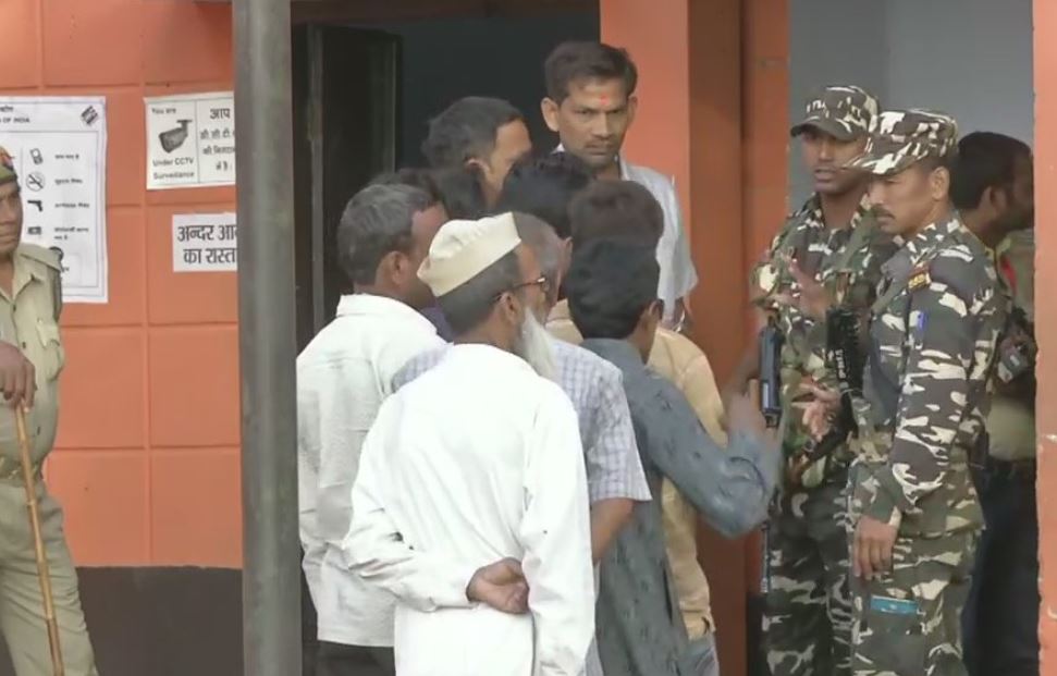 Voters queue up outside polling booth number 256 in Kannauj