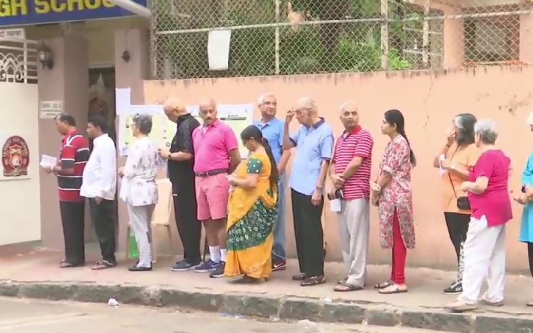 People Standing in queue to cast their vote