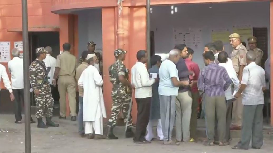 Voters begin to queue up outside polling booth number 256 in Kannauj