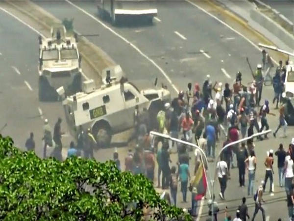 A Venezuelan National Guard (GNB) vehicle ploughs into opposition demonstrators in Caracas, Venezuela