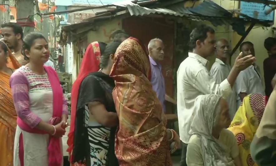 People standing in queue to cast vote