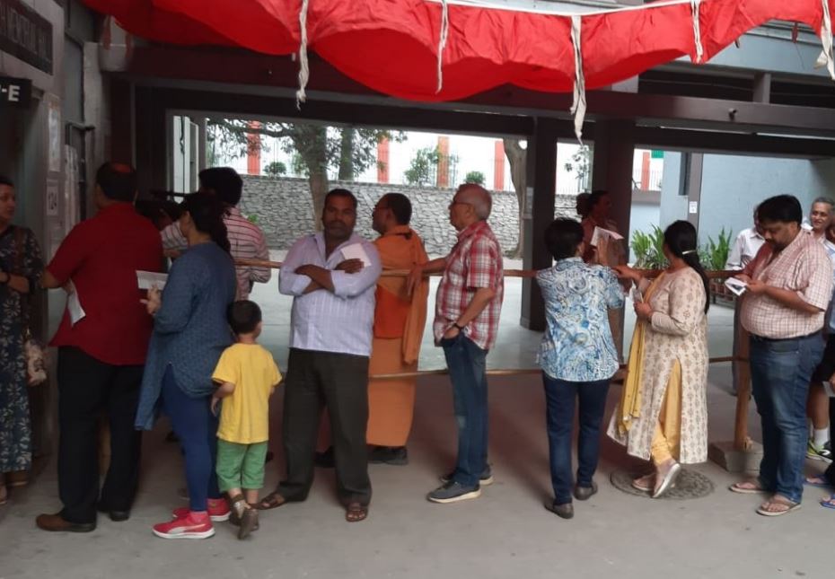 People standing in queue to cast vote