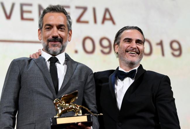 Director Todd Phillips poses next to Joaquin Phoenix after winning the Golden Lion for Best Film.