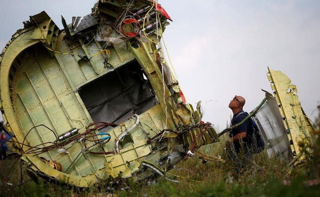 Malaysian air crash investigator inspects the crash site of Malaysia Airlines Flight MH17