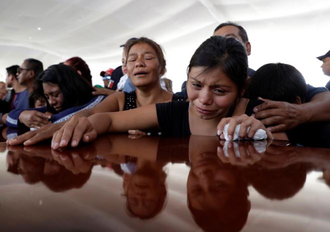 Relatives of a police officer, who was killed along other fellow police officers during an ambush by suspected cartel hitmen