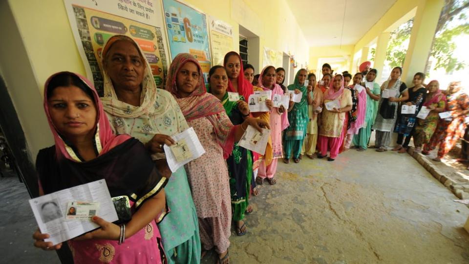 People standing in queue to cast vote