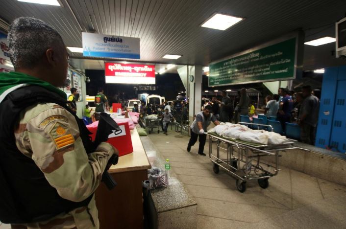 Rescue workers push stretcher trolleys carrying the bodies of dead village defence volunteers, who were killed by suspected separatist insurgents, at a hospital in Yala province