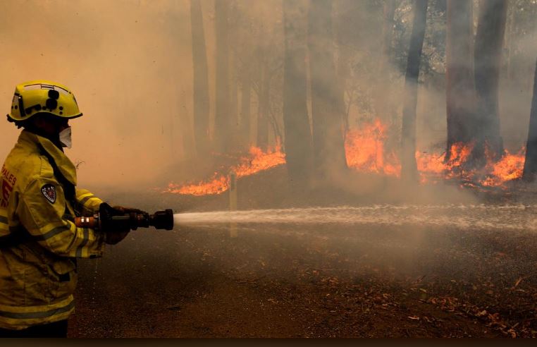 Smoke from a large bushfire is seen outside Nana Glen, near Coffs Harbour, Australia