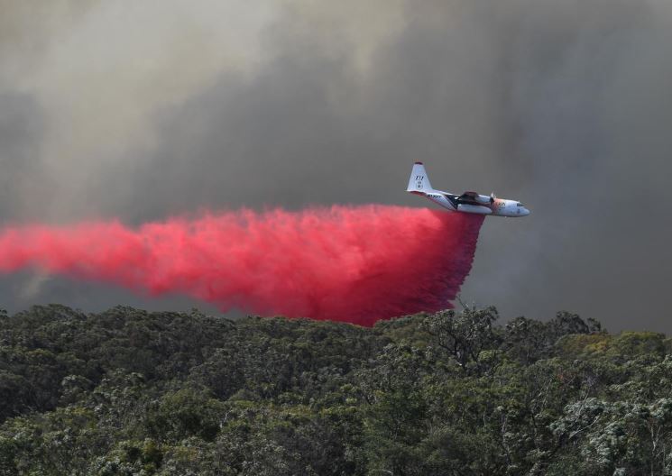 An air tanker drops fire retardant on the Gospers Mountain fire near Colo Heights, northwest of Sydney