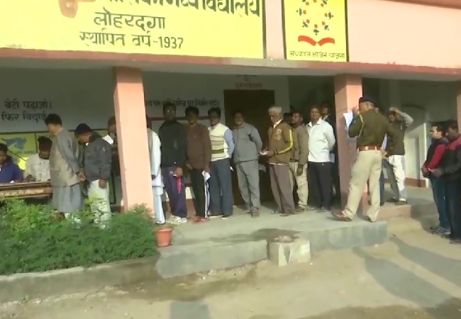 People standing in queue to cast vote