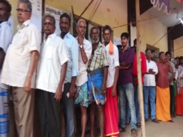 People Standing in queue to cast their vote