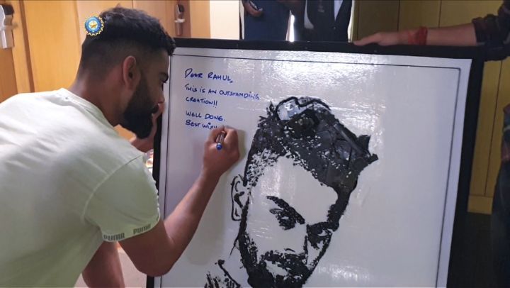 Virat Kohli with his portrait