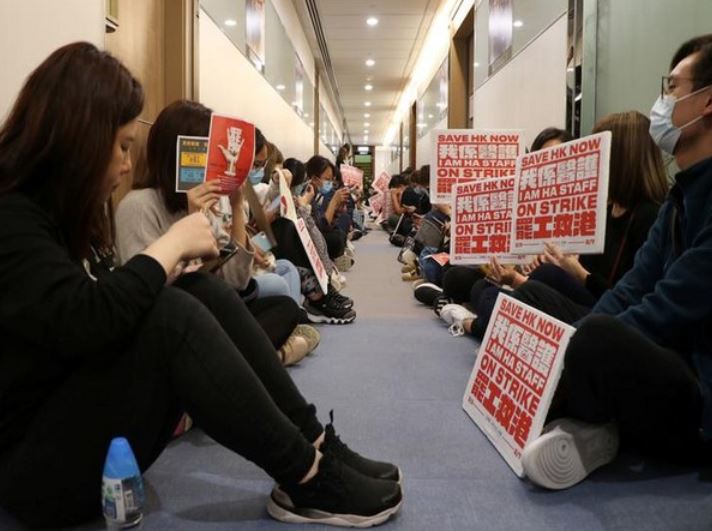 Medical workers wait at a corridor to demand an open dialogue on the novel coronavirus with the senior management, at the Hospital Authority's headquarters in Hong Kong