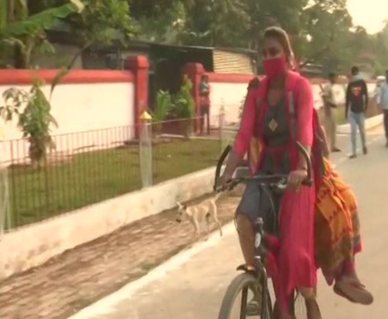 A first-time voter with her grandmother arriving at a polling booth in Patna