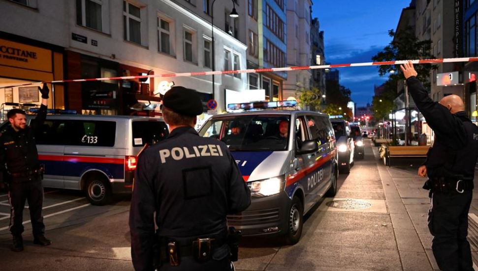 Police officers block a street after exchanges of gunfire in Vienna