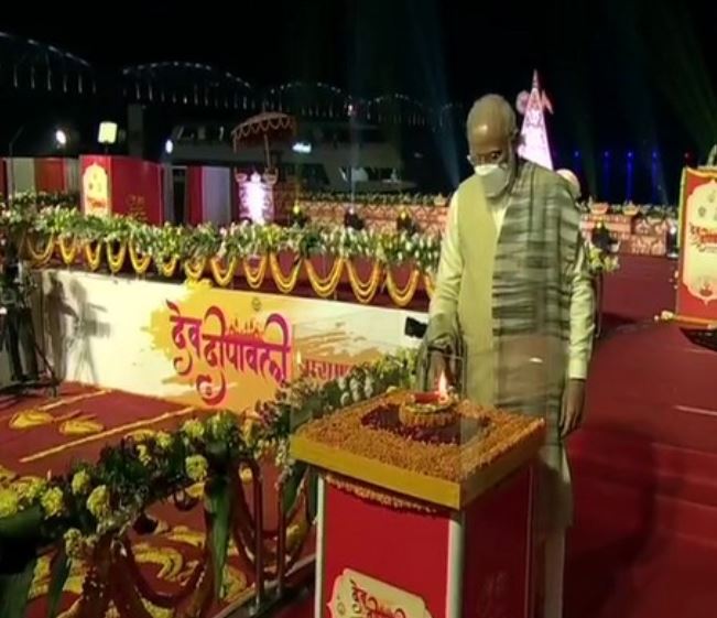 Prime Minister Narendra Modi lighting a lamp to launch Dev Deepwali Mahtosav in Varanasi