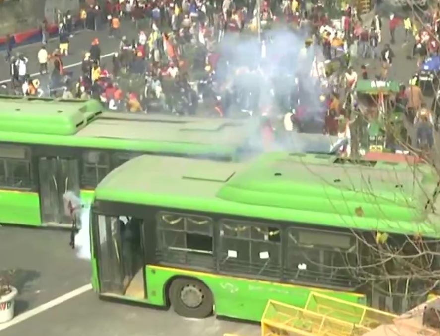 Police use tear gas shells to disperse the protesting farmers at ITO in central Delhi