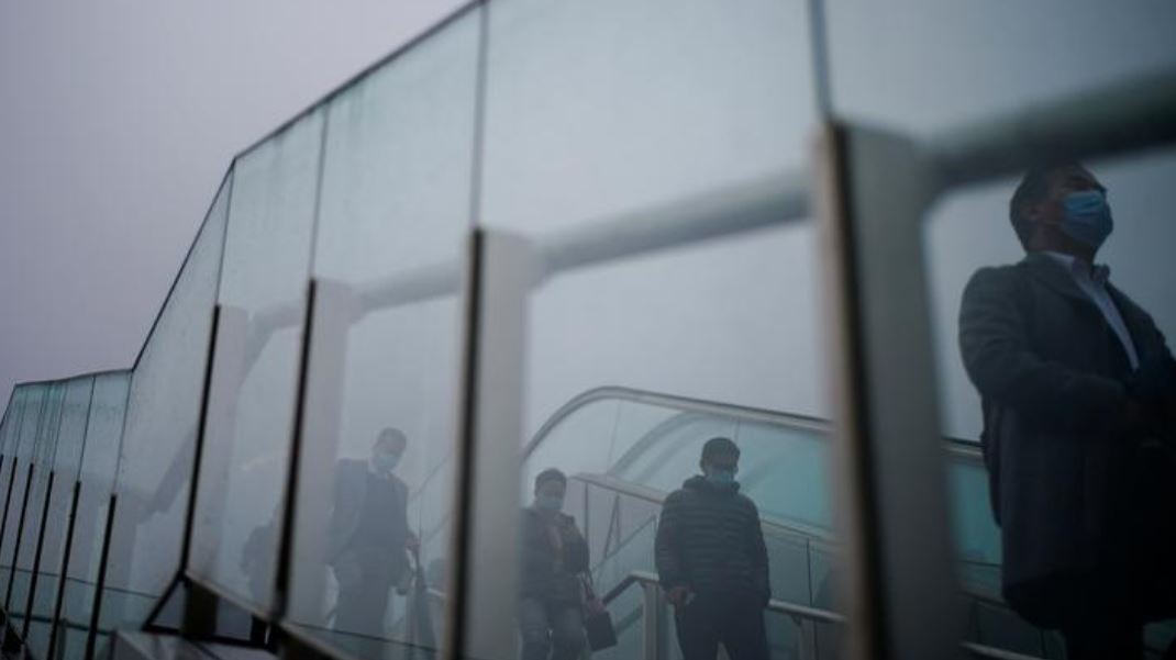 People wearing face masks descend a stairwell following the coronavirus disease (COVID-19) outbreak, in Shanghai