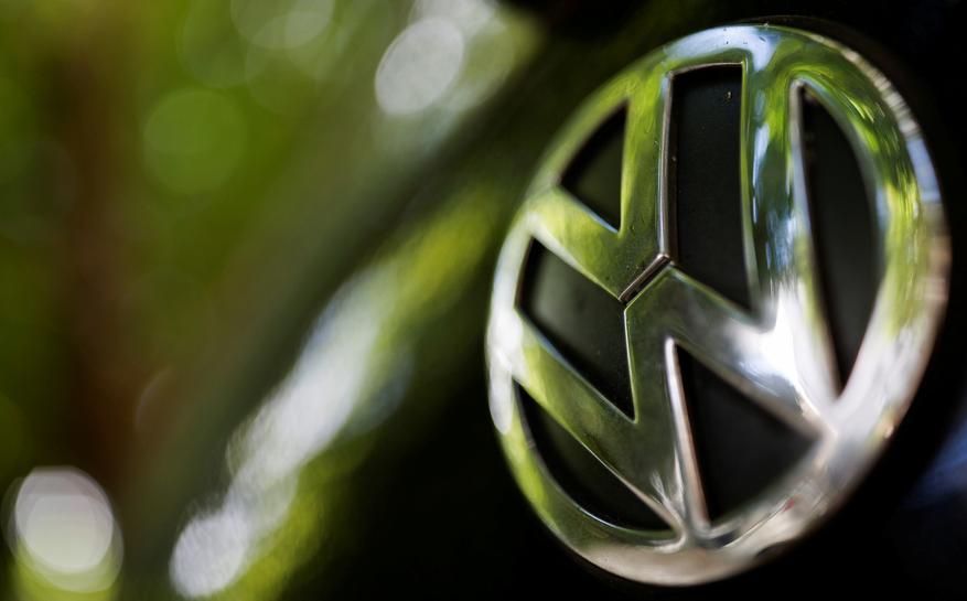 A logo of German carmaker Volkswagen is seen on a car parked