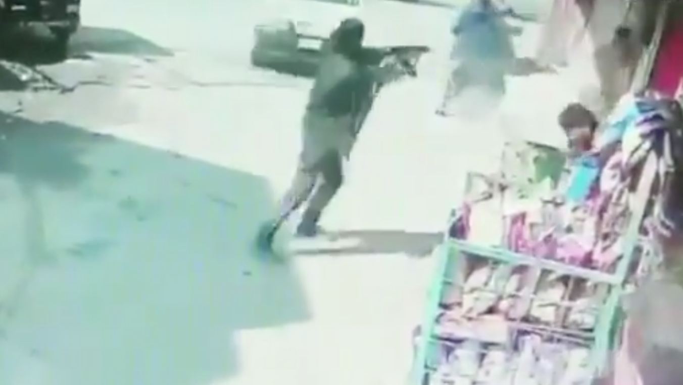 Terrorist opens fire in Baghat Barzulla of Srinagar district in Kashmir (A still from a CCTV Footage)