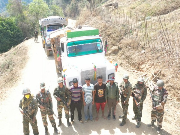 Visual of Assam Rifles with recovered contrabands and carriers