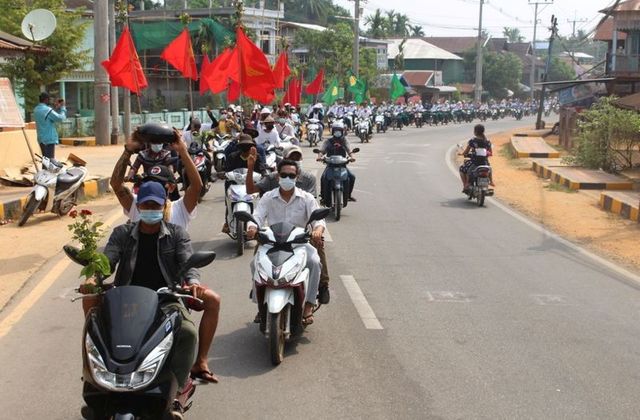 People take part in a motorcycle parade during a protest against the military coup, in Launglon township, Myanmar