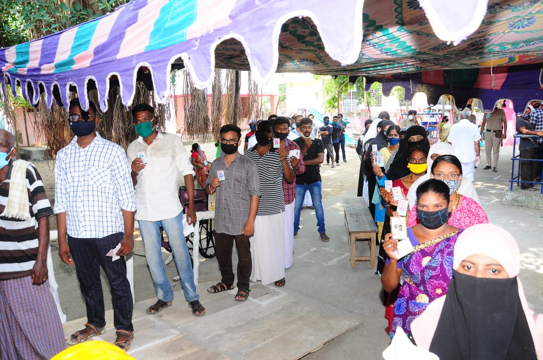 People Standing in queue to cast their vote