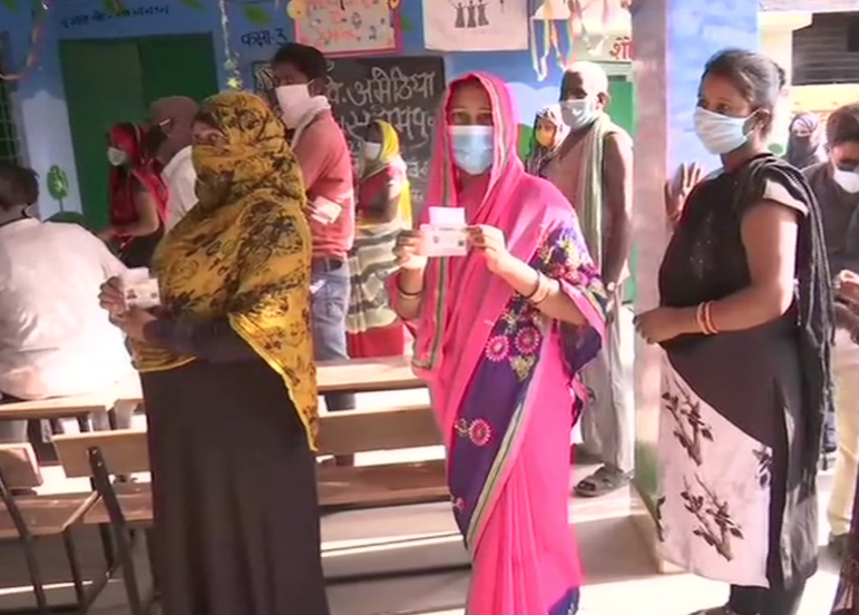 People Standing in queue to cast their vote