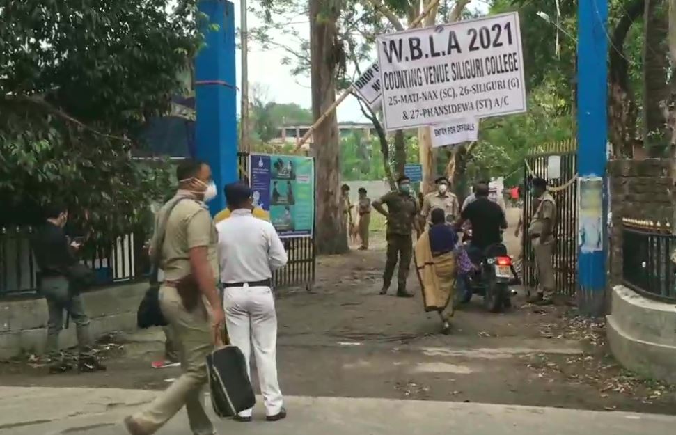 Officials, counting agents and others arrive at a counting centre at Siliguri College in Siliguri