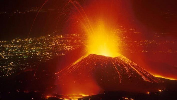 Smoke and flames are seen at the Nyiragongo volcanic eruption from the Tchegera Island on Lake Kivu