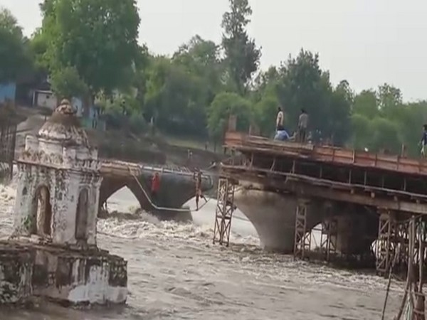 SDRF rescuing people after water level rose in the river in Sagar.