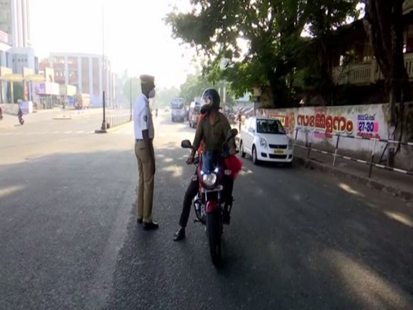 Police talking to a person on road during Sunday lockdown.