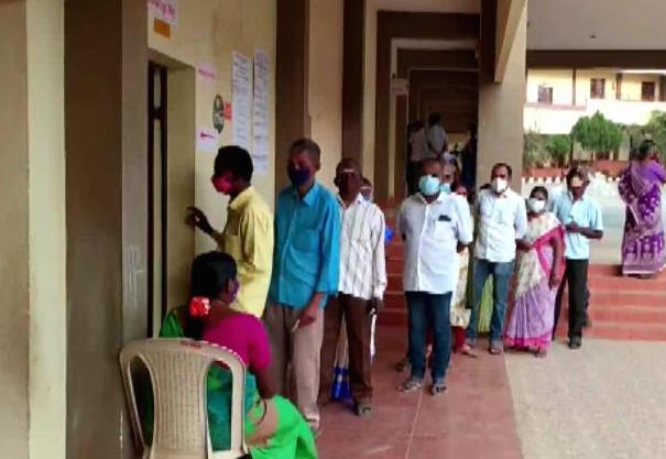 People Standing in queue to cast their vote