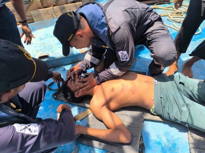 Indian Coast Guard officers administering medical care to rescued fisherman