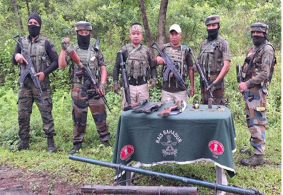 Manipur Police with recovered weapons